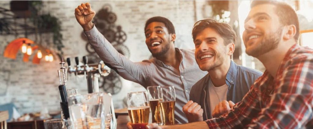 CGA sports betting men at the bar with drinks cheering